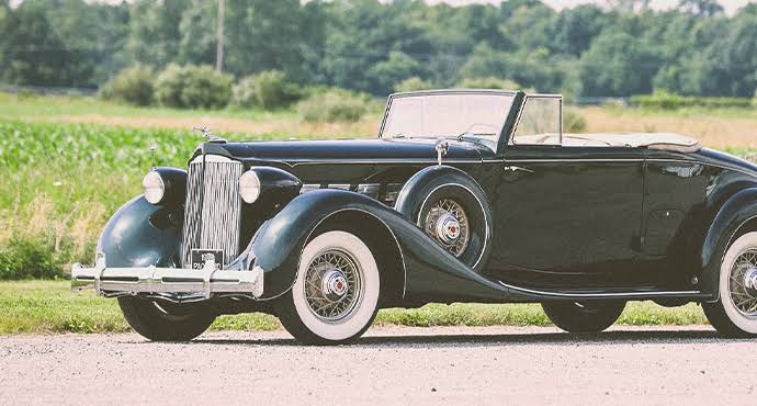 Restored antique car parked on a cobblestone street